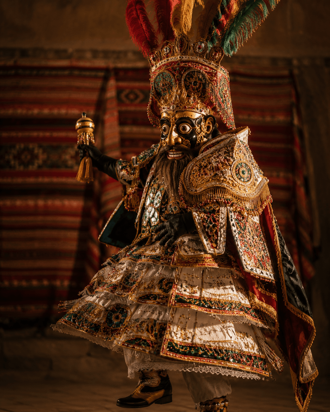 Morenada dancer in a feathered headdress, gilded mask, and richly embroidered multilayered costume, against an aguayo backdrop.